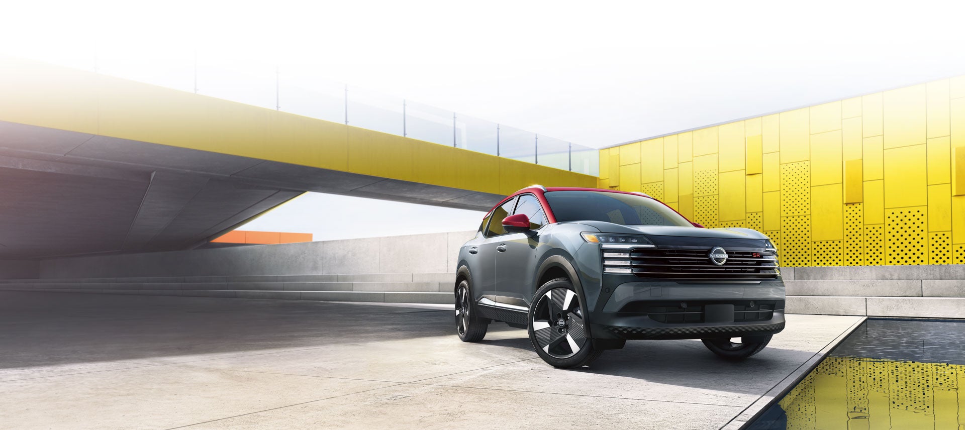 A three-quarter front exterior beauty shot showcasing a modern bridge with sunflare in the background.